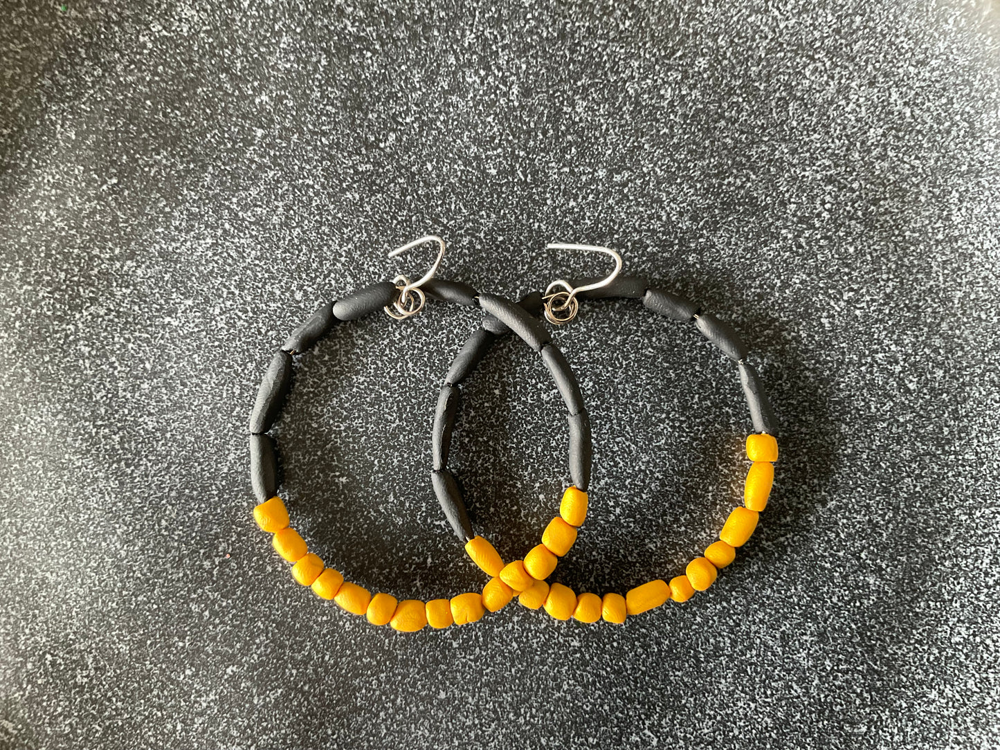 Hand rolled clay earrings - black + gold
